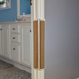 Bathroom with white cabinets, a sink, and a blue  wall and Jack's Scratcher installed on the door frame.