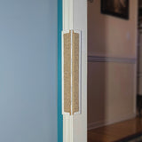 A door frame with a carpet Jack's Scratcher installed on it